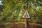 Old rusty, frayed, scratched red triangular traffic sign - pedestrian crossing in radioactive zone in Pripyat city