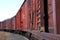 Old rusty freight train stands on rails