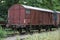 Old rusty freight wagon on the siding on overgrown railroad tracks, transportation concept, copy space