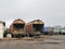 Old rusty freight wagons. A pile of firewood for kindling the boiler.