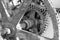 Old rusty gears of a medieval water mill in black and white