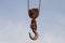 Old rusty hook of a hoisted crane in the port