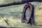 An old rusty horseshoe on an ancient wooden board. Retro. A symbol of happiness and good luck. Wooden background. Empty place for