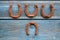 Old rusty horseshoe lucky symbols on blue wall