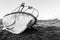 Old rusty iron boat on the shore. Black and white photo. Dramatic view