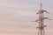 Old and rusty iron power tower in the evening light against the sky