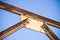 Old rusty iron structure with bolted metal profiles against a blue sky