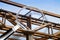 Old rusty iron structure with bolted metal profiles against a blue sky - Concept image seen through a magnifying glass