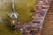 Old rusty lighted lantern on a stone wall, classic architecture and decorations