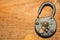 Old rusty lock on a wooden table. Vintage padlock on the wood background