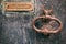 Old rusty mail letter box and rusty knocker on a weathered front door, text letters