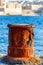 Old rusty marine bollard at port of Sliema, Malta