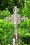 Old rusty metal cross in a cemetery