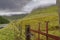 Old rusty metal gate and fence. Green fields and mountains. Gleniff Horseshoe drive loop county Sligo  Ireland