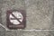 Old rusty metal no smoking allowed sign on dirty pebbles stone wall texture in public place