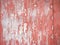 Old rusty metal texture. Peeling painted red surface. Grunge background with damaged paint.