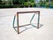 Old and rusty mini soccer football goal on basketball concrete f