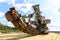 Old rusty multi bucket excavator, giant stacker, absetzer in sandy career