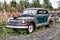 Old rusty oldtimer in South Eeast Iceland. Trees in the back