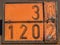 Old and rusty orange plate with hazard identification number