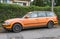 Old rusty orange VW Passat hatchback parked