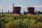 Old rusty overgrown abandoned cooling tower of factory