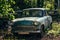 Old rusty overgrown abandoned soviet retro car