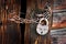 Old rusty padlock on rural wooden gate