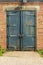 Old rusty padlocked blue metal door
