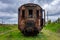 Old rusty passenger car abandoned on railway tracks