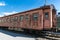 Old rusty passenger railway wagon with peeling paint