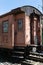 Old rusty passenger railway wagon with peeling paint