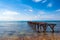 Old rusty pier in the sea and blue sky background