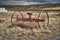 Old rusty plow in a field in Iceland