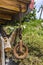 An old rusty pulley hanging on the corner of an alpine hut