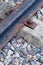 Old and rusty rail part railway track close-up on a gravel background