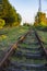 Old rusty rails of an abandoned railway leaving afar