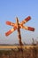 Old and rusty red and white railroad cross signpost