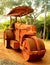 An old rusty road roller on the road.