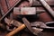 Old rusty rugged anvil and other blacksmith tools.