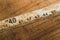 Old rusty ruler with black numbers on a working wooden table. vintage measuring tape. industrial background