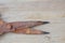 Old rusty scissor blade on wooden board