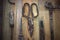 Old rusty scissors, nails on a wooden surface, top view. Old tool.