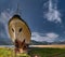 Old rusty ship on a slipway on the shore of a lake against a blue sky with high clouds