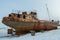 Old rusty ship on winter shore of Lake Baikal.