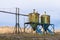 Old rusty silos for food by the lake