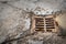 Old rusty street grate near the sea in Cres