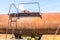 Old rusty, tank wagon, top detail with bridge, handles and valve