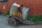 Old rusty tanker truck trailer on brick wall background.