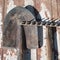 The old rusty tools, implements or household equipment on wooden background.